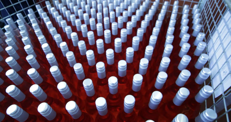 Detail of group of pink wine bottles in metal bascket. Storage stage ready for send away. Beverage production industry. Mendoza, Argentina