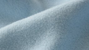 Light blue polar fleece blanket slow pan 4K footage