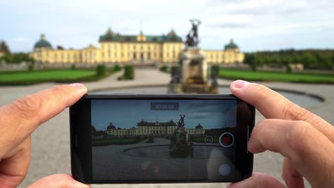 DROTTNINGHOLM - SEPTEMBER 20, 2018: Drottningholm Palace, Stockholm, seen through a smartphone display