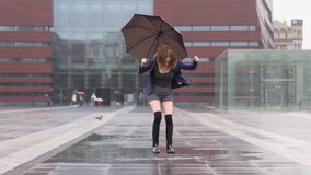 Fun good mood for rainy weather woman in rubber boots jump in puddle with splash - Powered by Shutterstock - Get 15% off with code: PIKWIZARD15