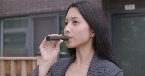 Asian woman vaping cannabis