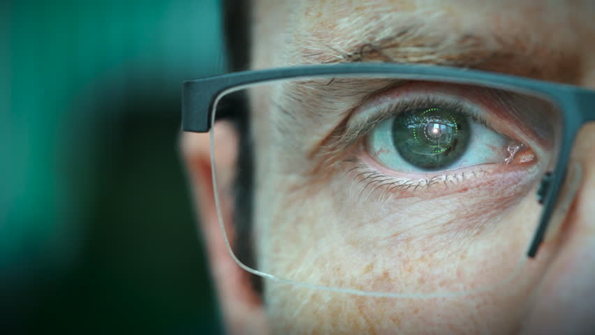 A close up of a businessman eye controlling a futuristic computer system with an Fake News concept. Royalty-Free Stock Footage #1016637769