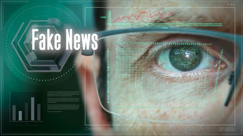 A close up of a businessman eye controlling a futuristic computer system with an Fake News concept.