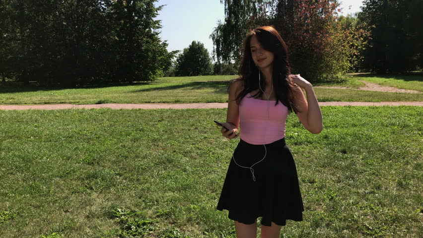 Music is always with me. Young beautiful Brunette woman listening to a song