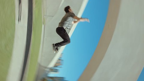 Man doing extreme backflip outside in city park flipping with camera