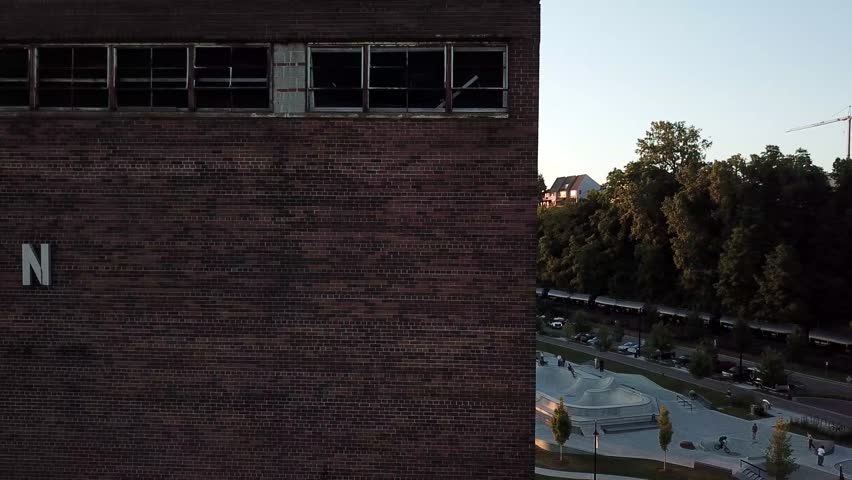 City of Burlington sign on abandoned building overlooking skate park at sunset.