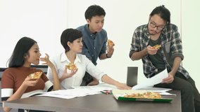 Business people eating pizza is break time and meeting team together for success project. Concept of teamwork, relax, creative working and sharing idea.