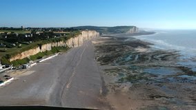 Drone footage of the beach huts, tide pools, the beach & the cliffs of Mesnil-Val-Plage, France.