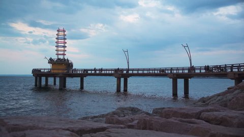 Burlington pier at dusk with groups of people on it