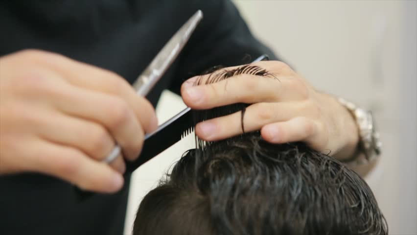 Barber Cuts the Hair in the Barbershop. Man hairdressing with scissors cuts the Hair. Slow Motion. Close Up Royalty-Free Stock Footage #1016654476