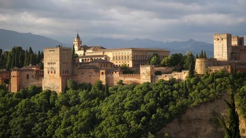 Alhambra panoramic scenic view with blue cloudy sky at sunset in Granada. Andalucia, Spain.