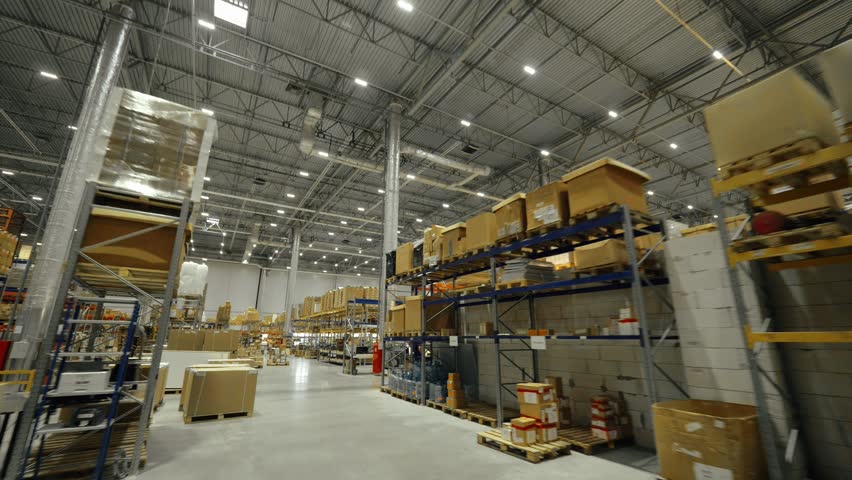 High shelves and racks with boxes in logistic storehouse on manufacturing plant. Industrial warehouse for storage finished products and goods for loading Royalty-Free Stock Footage #1016660302