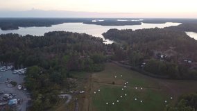 Aerial view of a big Island in the Swedish Archipelago. Late summer evening. Drone flies forward over the Swedish countryside. Beautiful sunset scenery.