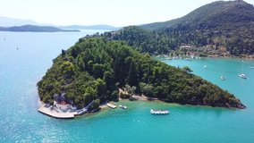 Aerial drone bird's eye view video of iconic port of Nidri or Nydri a safe harbor for sail boats and famous for trips to Meganisi, Skorpios and other Ionian islands, Lefkada island, Ionian, Greece