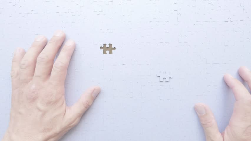 Personal perspective of a man putting the last piece of the jigsaw into place