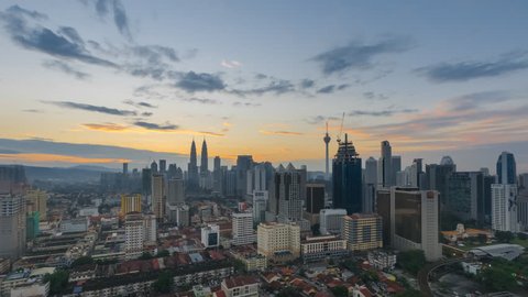 Time lapse of sunrise in cityscape Kuala Lumpur, Malaysia. Night to Day Aerial View. Zoom in motion timelapse. Prores 4K.