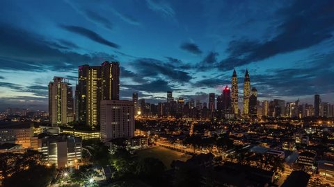 Time lapse of Kuala Lumpur City Center from night to day transition with beautiful cloud formation. Diagonal bottom to top transition effect