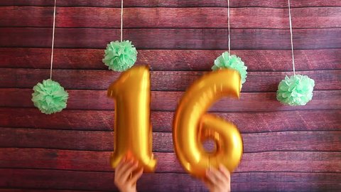 Happy sixteen birthday, golden air balloons with number 16, anniversary celebration with decorations