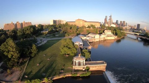 Aerial Drone Footage of Philadelphia Skyline, During A Sunny With Clear Skies Evening, Rotating 360 Degrees Around Schuykill River and Park Behind Philadelphia Art Museum and Fairmount Water Works