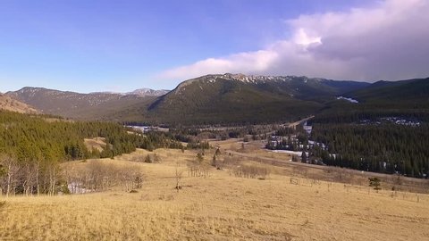 Foot Hills and Mountain Reveal. A calm aerial drone view of the foothills and Rocky Mountains