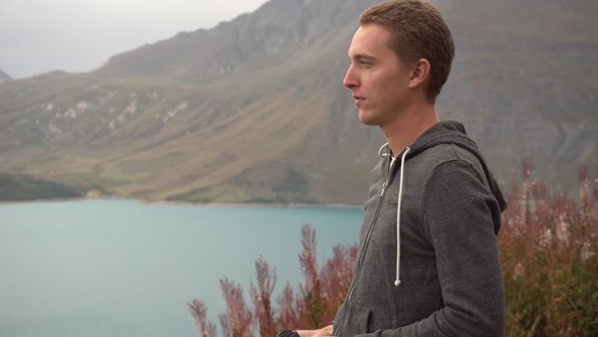Young Beautiful Successfull Man Watching the Landscape with a Telescope