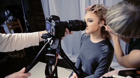 The operator removes the camera makeup on the girl