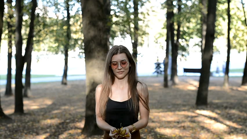 beautiful girl is spinning in the park, autumn abstract