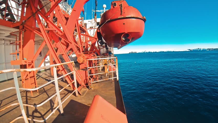 Orange lifeboat for emergency evacuation loading for safety
