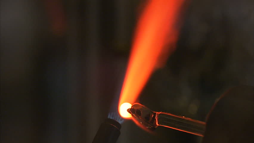 close up shot of someone blowing glass.