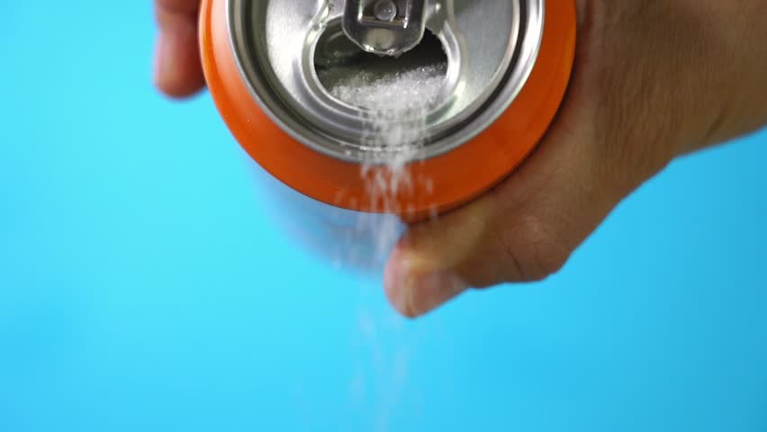Hand holding soda can pouring lots of sugar in metaphor of sugar content of a refresh drink in healthy nutrition, diet, sweet and carbonated drinks addiction and unhealthy food concept. | Shutterstock HD Video #1016728267