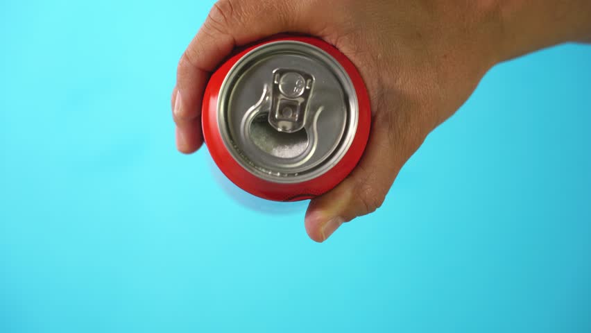 Hand holding soda can pouring lots of sugar in metaphor of sugar content of a refresh drink in healthy nutrition, diet, sweet and carbonated drinks addiction and unhealthy food concept. | Shutterstock HD Video #1016728276