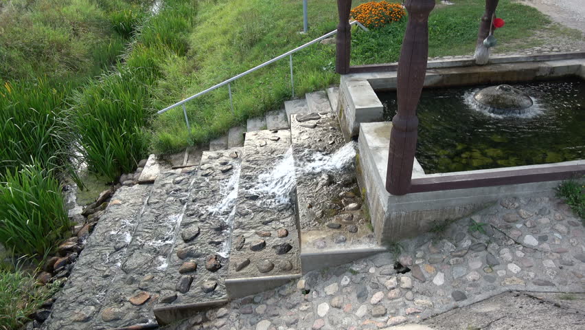 Protected natural source of spring water near river