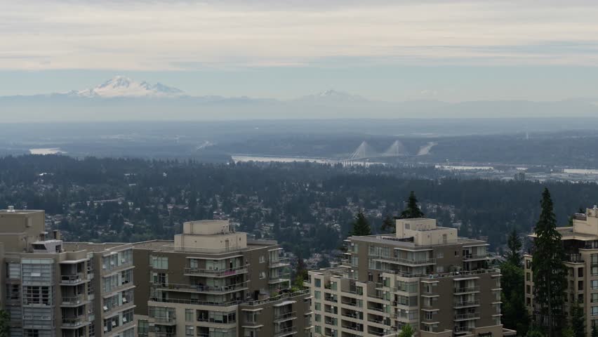 Aerial timelapse of a residential neighborhood during a cloudy summer day. Taken on top of Burnaby Mountain, Vancouver, BC, Canada.