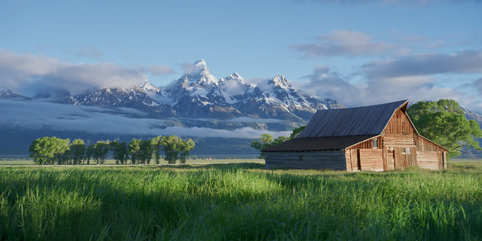 Grand Teton barns and mountains during a cloudy summer morning