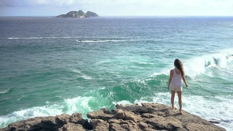 Brazilian young woman felling fun and free in the paradise nature of Joatinga secret beach of Rio de Janeiro , Brazil