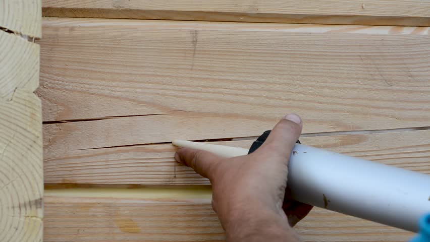 Sealing of joints and cracks, insulation, painting, wooden house at a height with a sprayer, paint syringe and sealant at a height of metal scaffolding | Shutterstock HD Video #1016756479