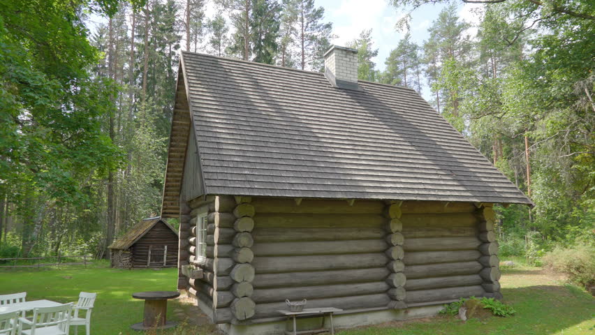 Closer look of the wooden hut in the forest with the wooden shingles of the roofs