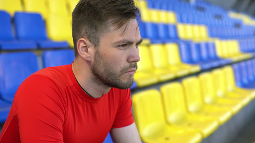 Young man sits on a tribune