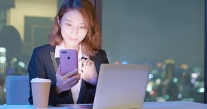 business woman use phone and notebook work at night