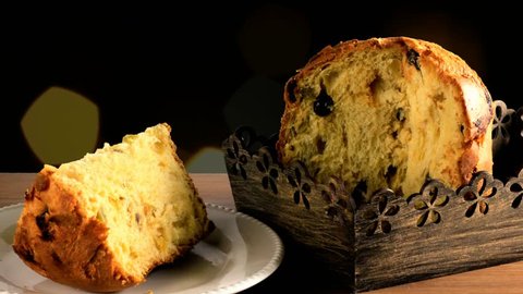panettone on wooden table, background with flashing bokeh lights, close up