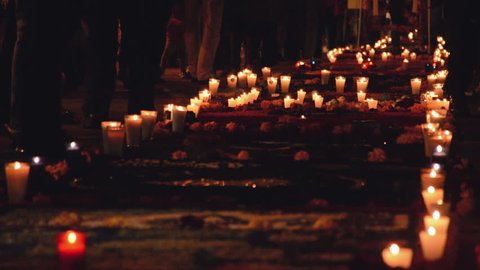 Crowd of people on a path of candles during the day of the death festival, (Día de los muertos)