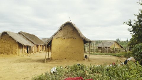 Poor african clay hut in village in Madagascar. Handheld
