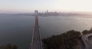Aerial footage from Treasure Island in San Francisco, flying over the water towards the San Francisco-Oakland Bay Bridge and the San Francisco skyline.