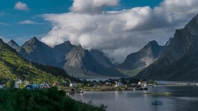 The movement of clouds over beautiful mountain peaks and a small fishing village in Norway, Reine. This is a fishing village on the lofoten islands, and popular tourist destination. Lofoten Islands