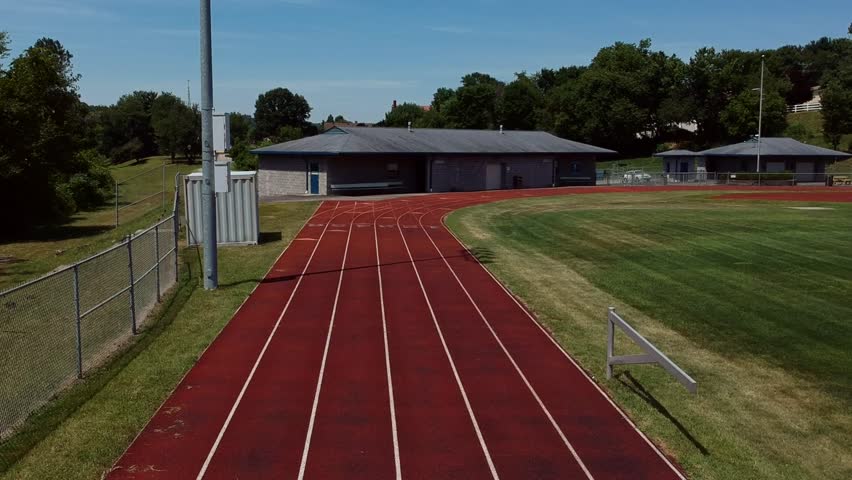 A drone shot of some running tracks along a football field.