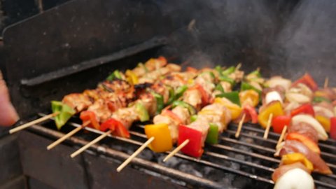 close up chicken kebabs kabobs in smoking BBQ