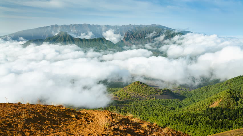 Zooming timelapse sequence of tradewind clouds moving against the mountains of La Palma between the Caldera de Taburiente in the background and Cumbre Vieja. Seen from the top of the volcano Birigoyo 