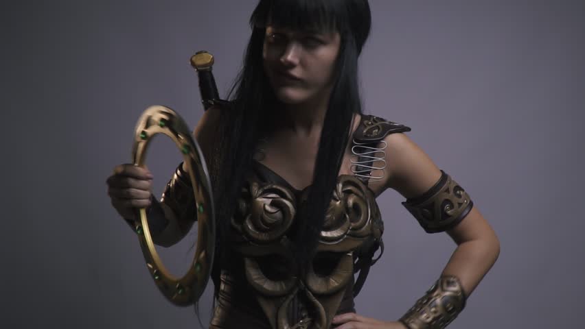 The uncultured Amazon woman warrior picking teeth and looks around, slow motion