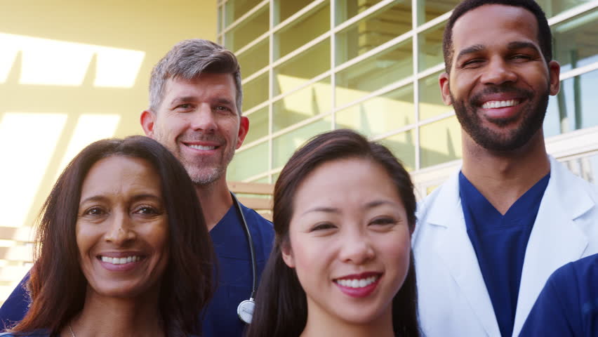 Medical team smiling to camera, close up panning shot