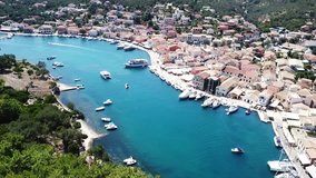Aerial drone bird's eye view video of iconic small safe port of Gaios with traditional Ionian architecture and sail boats docked, Paxos island, Ionian, Greece